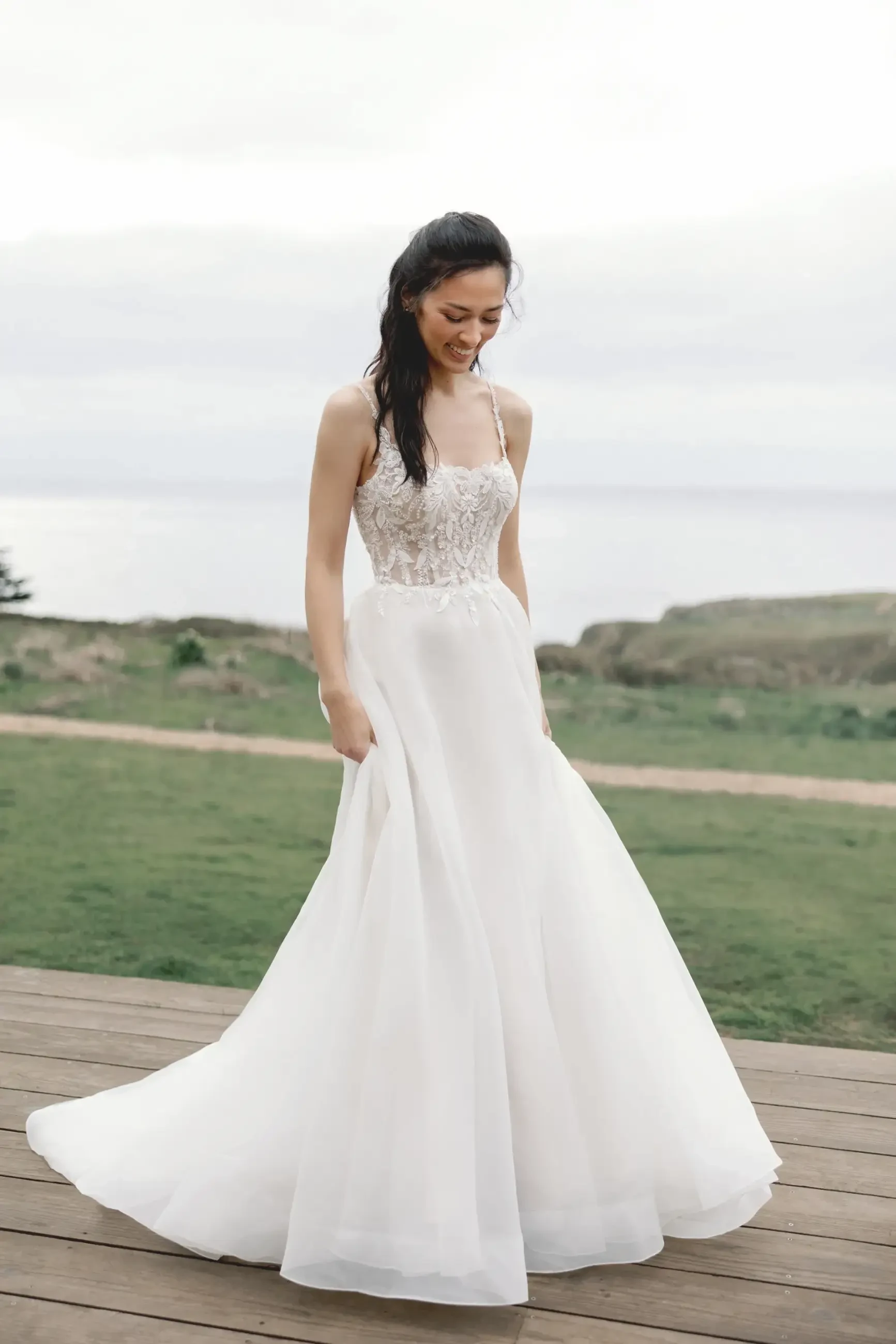 model is wearing a sleeveless a-line bridal gown