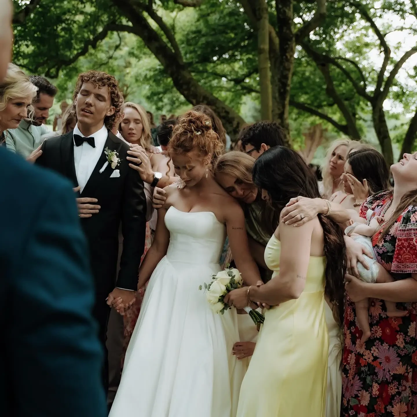 image shows a real couple with their family on their wedding day in british vogue