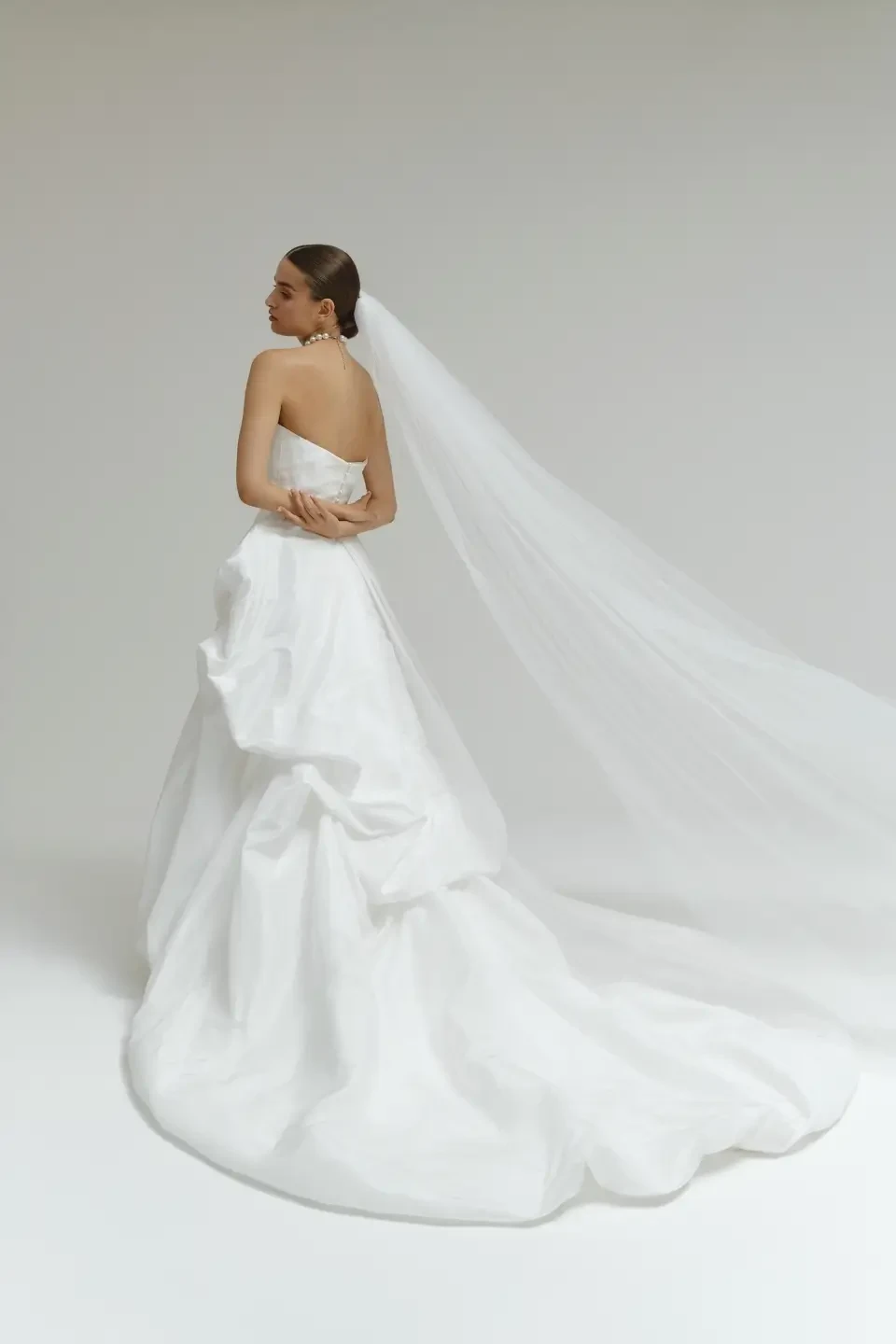 model is wearing a strapless wedding dress