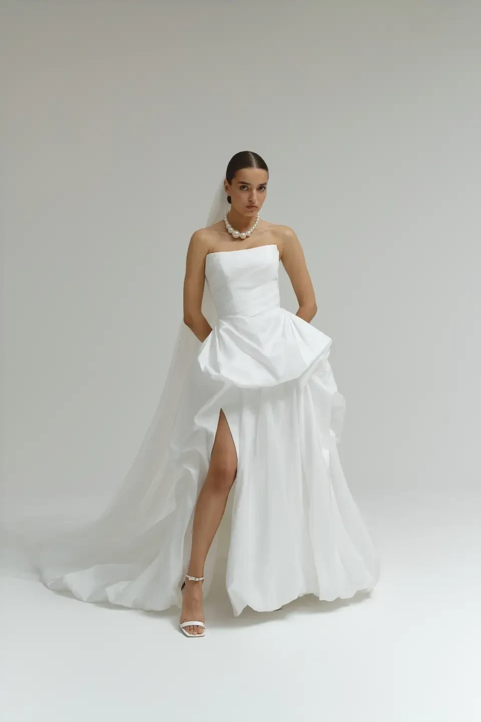 model is wearing a strapless wedding dress
