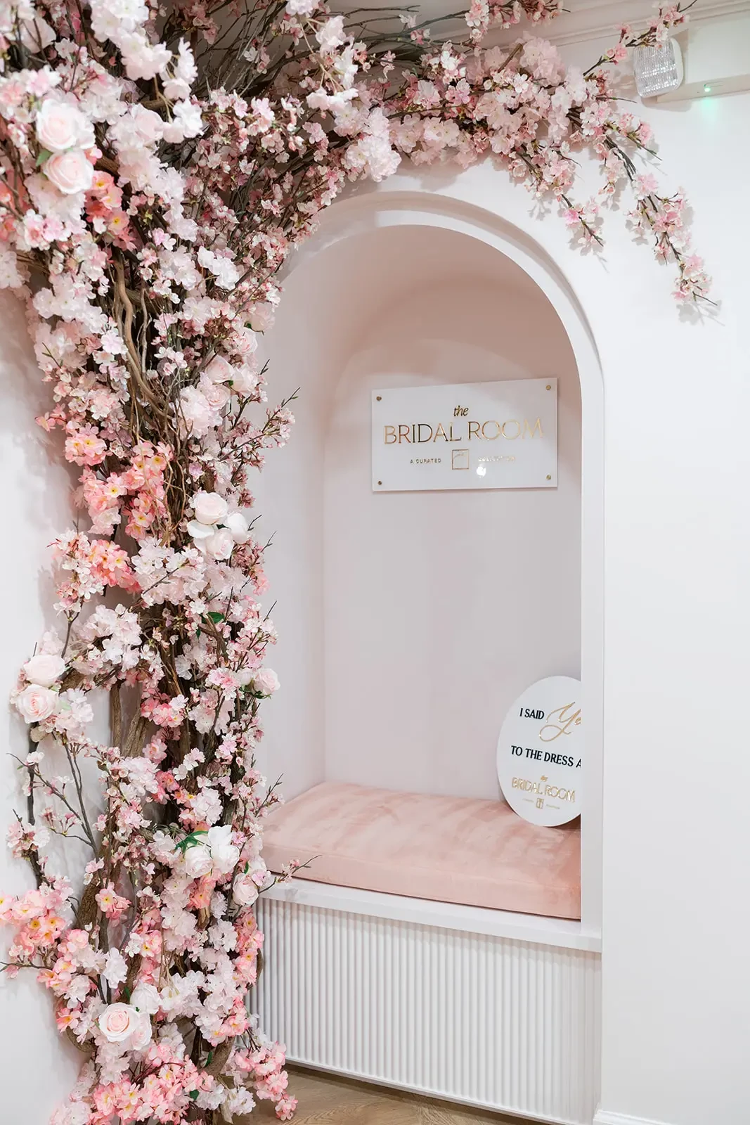 Image shows a photo booth where brides can hold up an “I said yes to the dress” sign