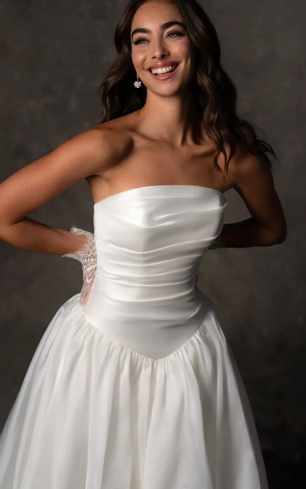 model is wearing a strapless basque waist wedding dress