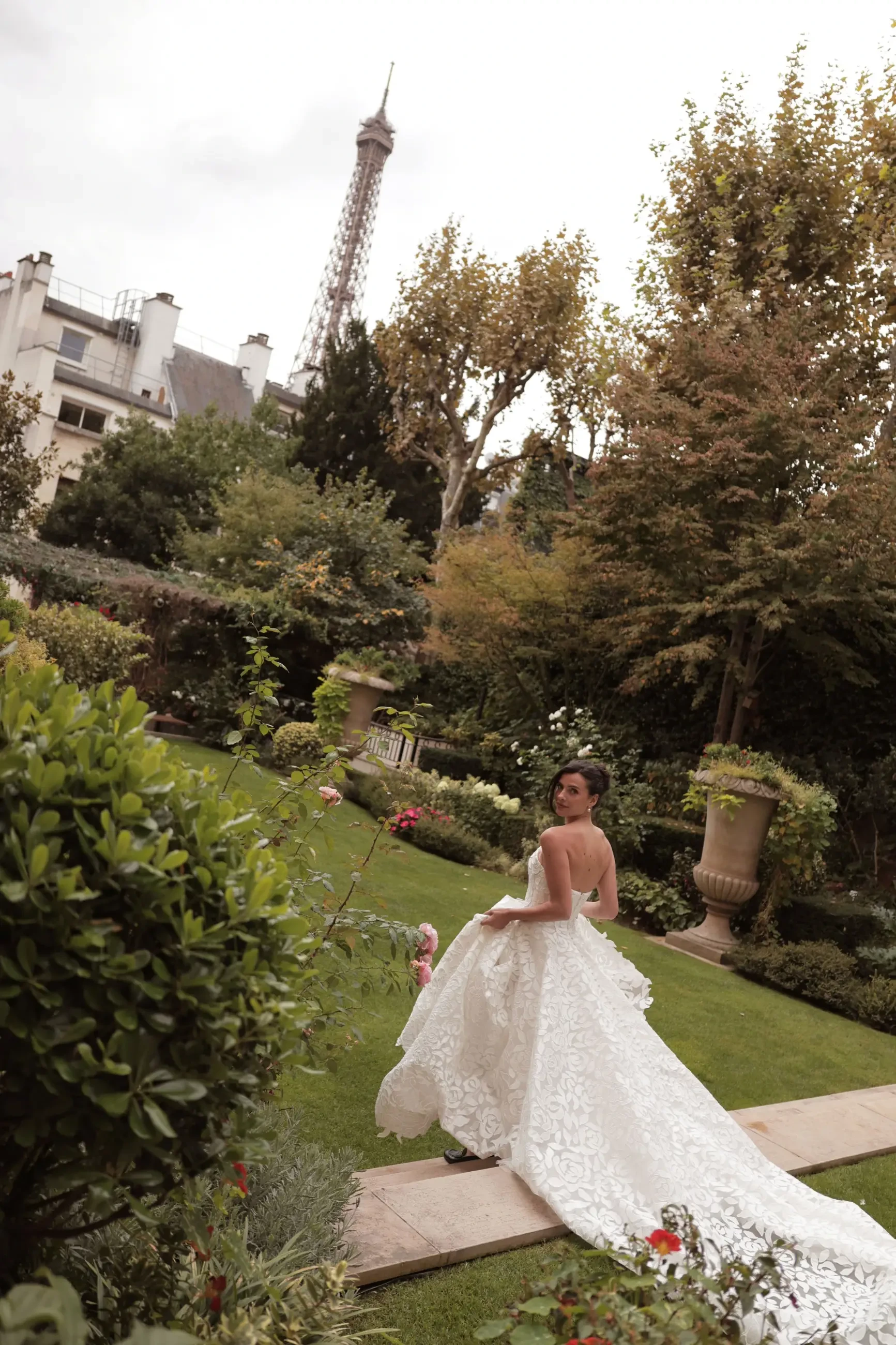 model is wearing a strapless allover lace a-line bridal gown