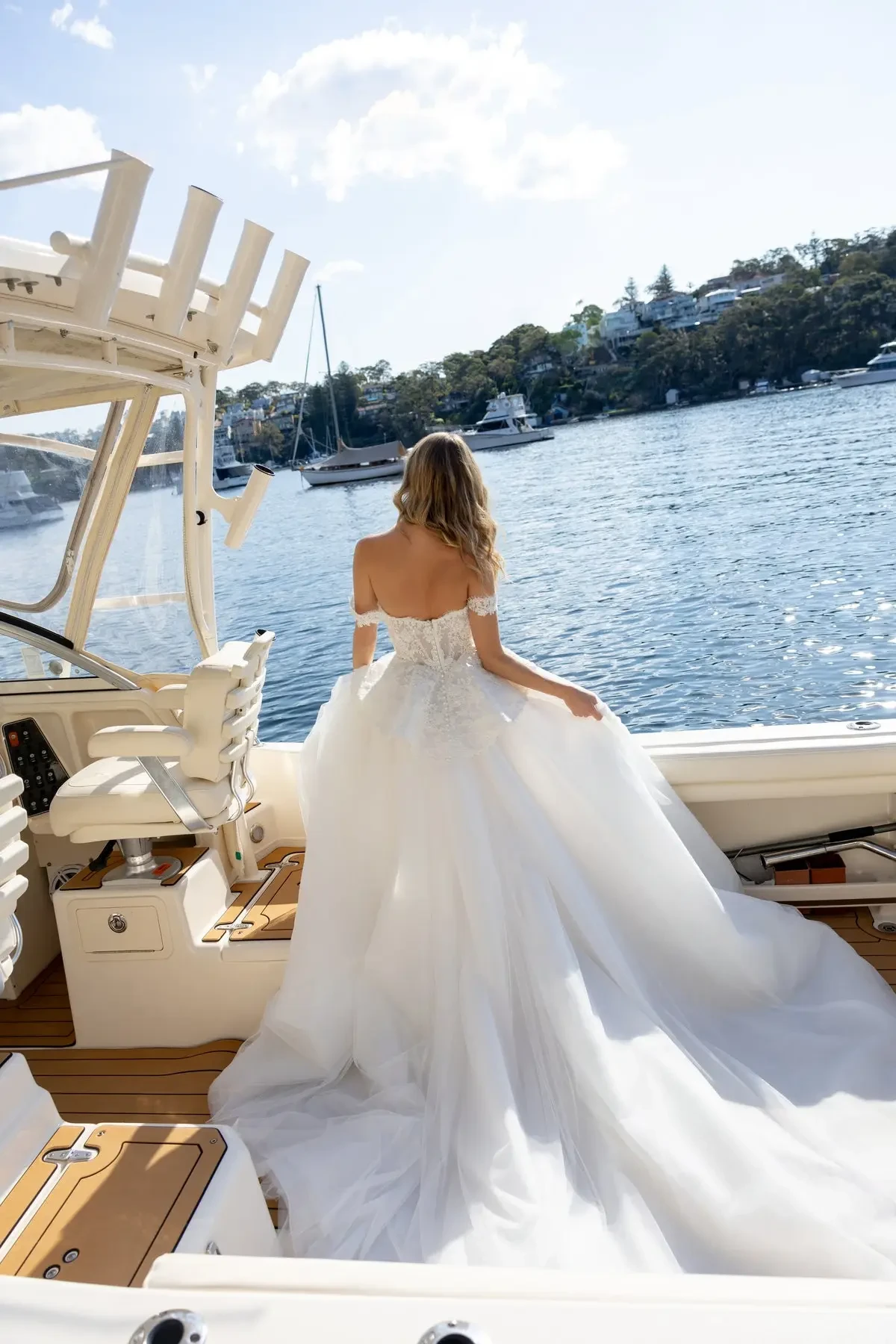 model is wearing an off the shoulder a-line wedding dress