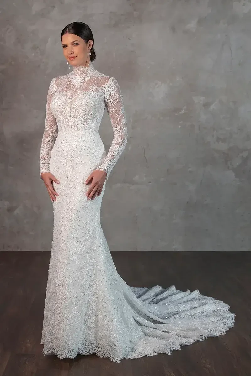 model is wearing a long sleeve high neckline lace wedding dress