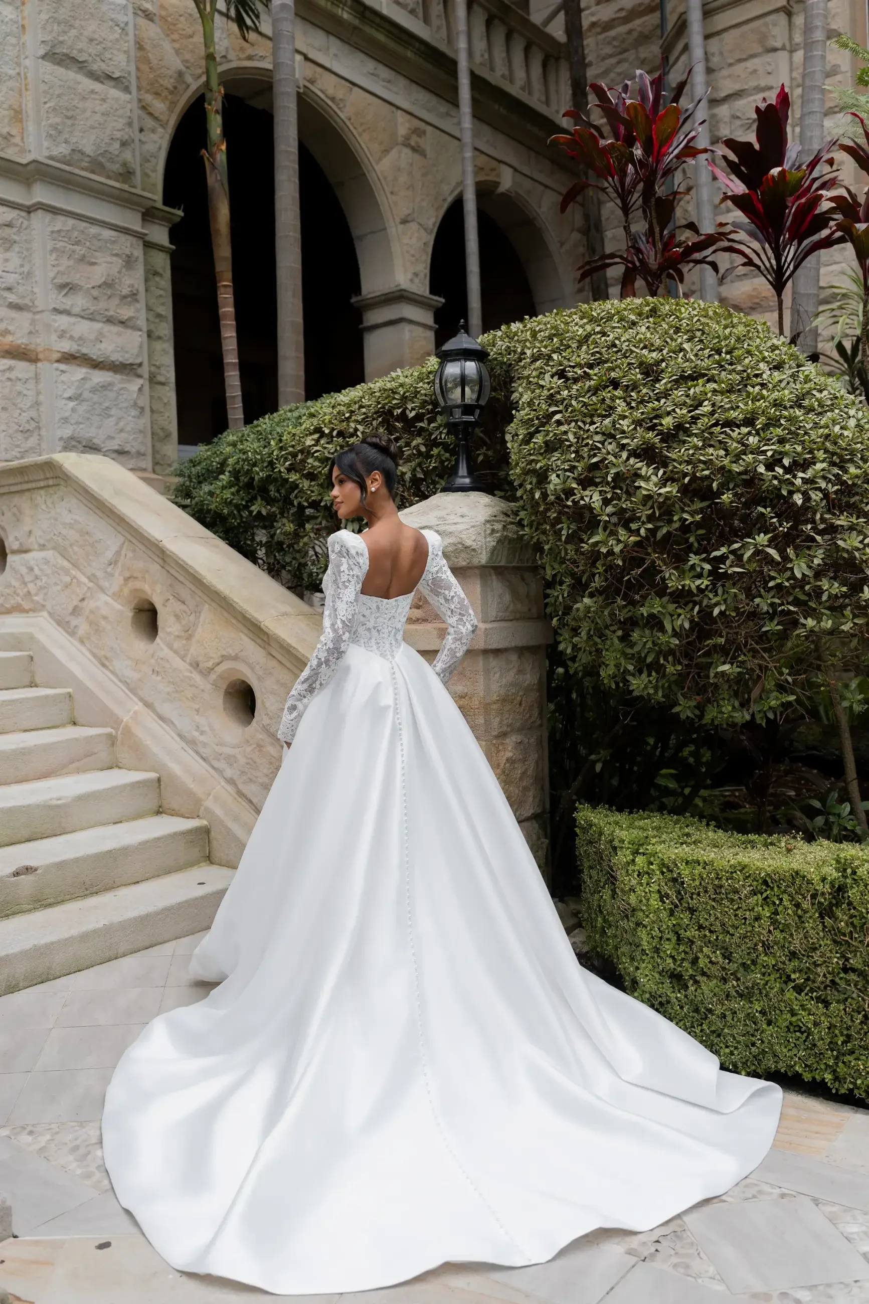 model is wearing a long sleeve sweetheart neckline ball gown wedding dress
