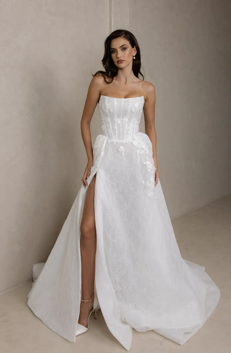 model is wearing a strapless a-line wedding gown
