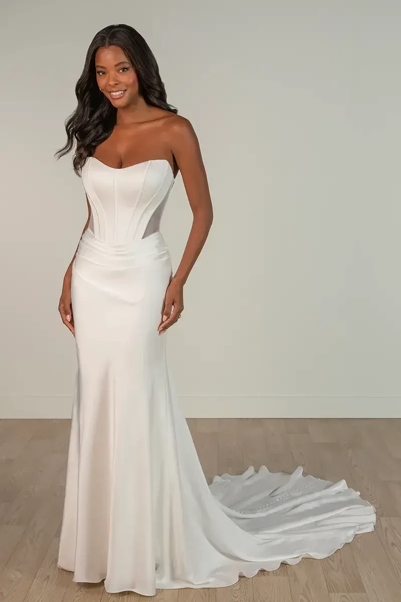 model is wearing a strapless fit and flare bridal gown